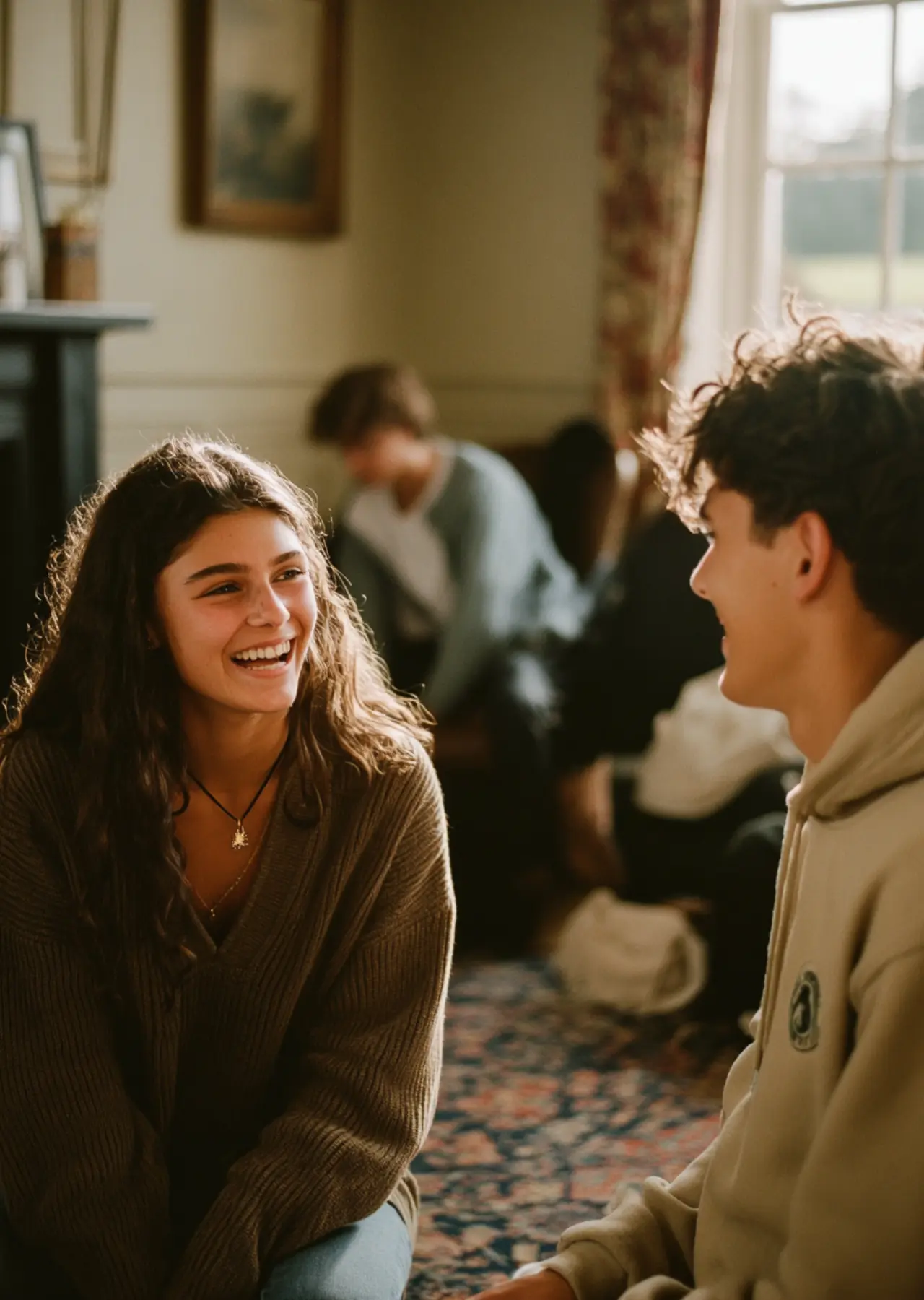 Teenage girl and boy enjoying free time after group therapy in residential rehab for teenagers.